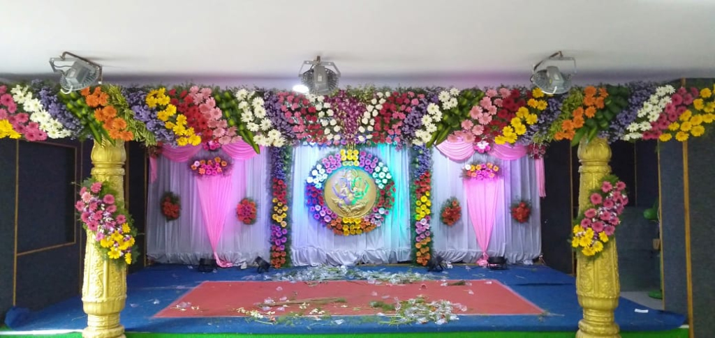 Grand Traditional Ganesha Wedding Stage with Gold Pillars & Rainbow Floral Arch