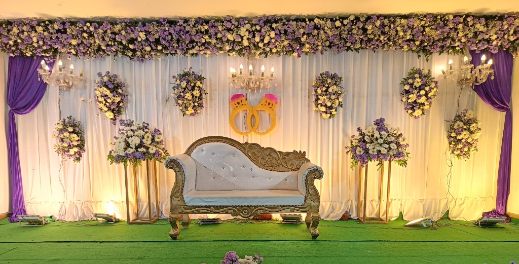 Purple Drapery Wedding Reception Stage with Royal Sofa & Ring Motif
