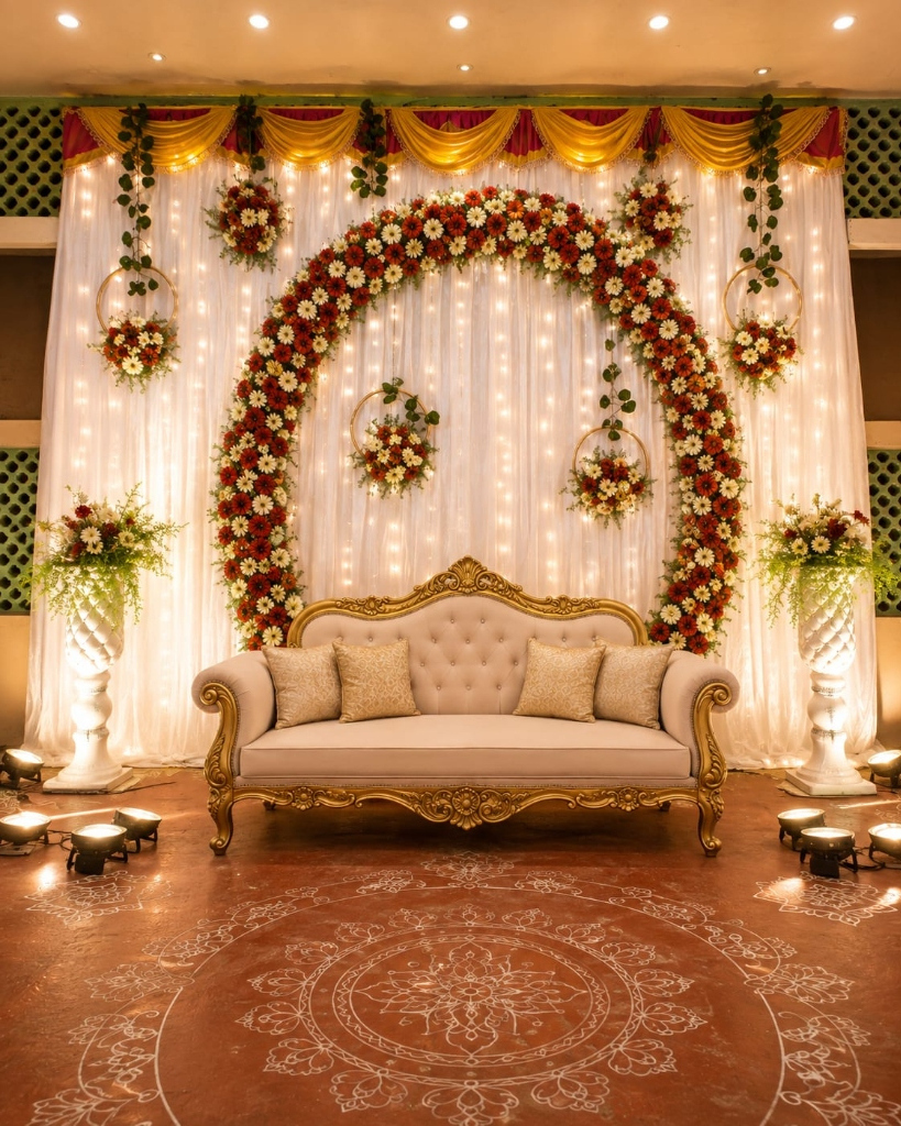 Circular Floral Ring Arch with Fairy Lights, Gold Sofa & Floor Rangoli